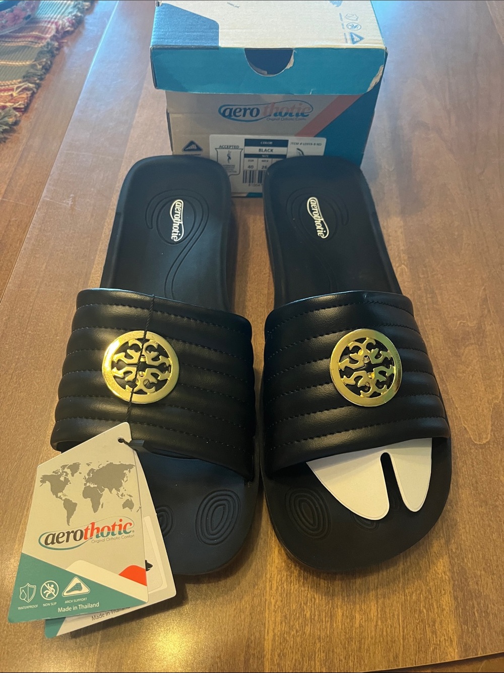 Aerothotic Women's Black Slide Sandals with Gold Medallion